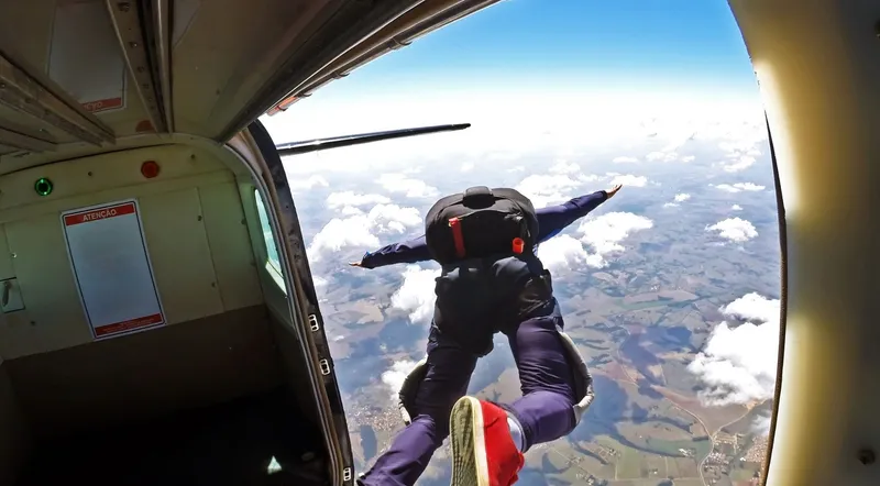 Tandem skydiver leaving the airplane at 4,000 metres over Interlaken