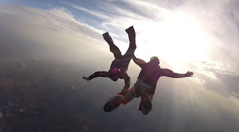 Tandem skydiver in freefall high above the Swiss Alps near Interlaken