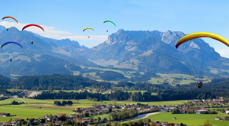 Tandem paraglider over the green Interlaken valley between the two lakes